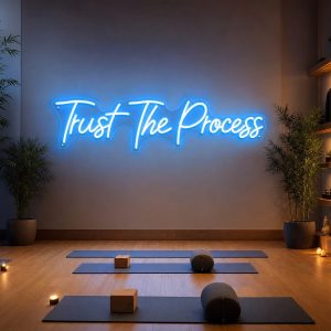 Ice Blue 'Trust The Process' neon sign mounted on a dark wall in a modern home gym with exercise equipment in the background, cinematic lighting.