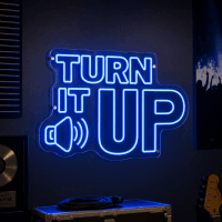 Turn It Up LED neon sign glowing in a music venue