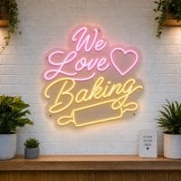 We Love Baking LED neon sign with heart, rolling pin, and cupcake icons on clear acrylic backing