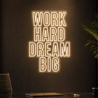 Work Hard Dream Big LED neon sign in warm white in luxury entrepreneur office with cinematic lighting